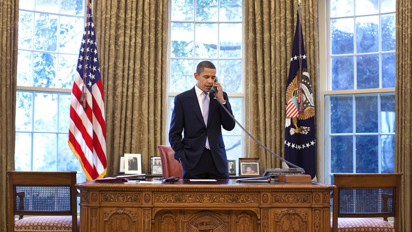 President Obama talks on the phone in the Oval Office