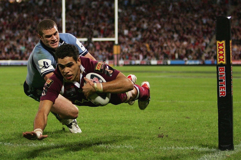 Greg Inglis gets airbourne as he scores a try