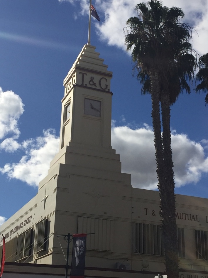 T and G Mutual Life Insurance Society's double-storey white building with a clock tower featuring a pyramid atop.