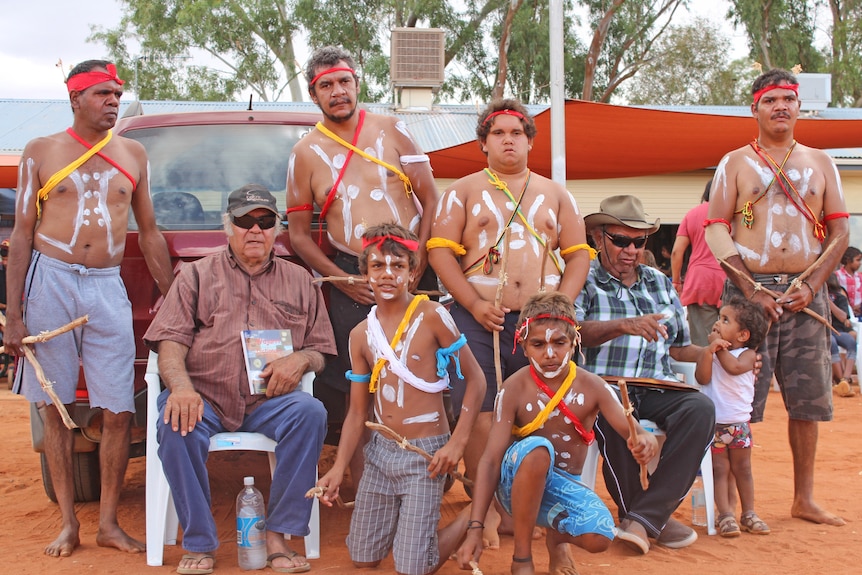 Wajarri dance group and elder with the dictionary