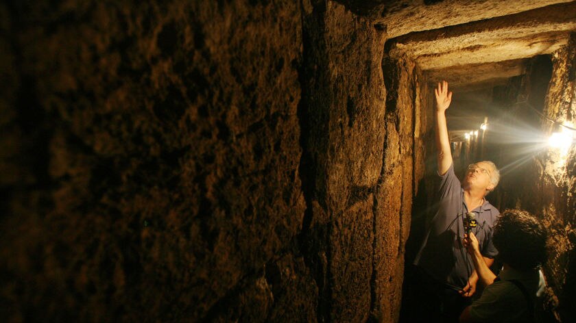 Escape from Romans: Professor Ronny Reich of Haifa University stands inside the tunnel under the Old City