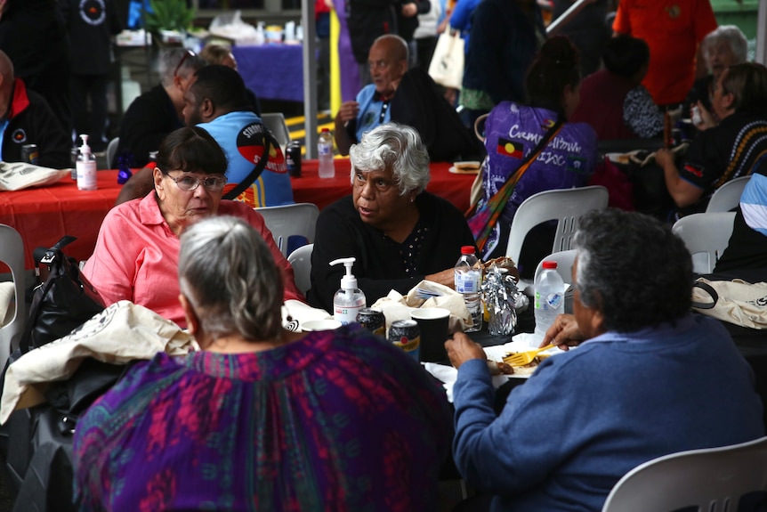 Indigenous women sat at a table