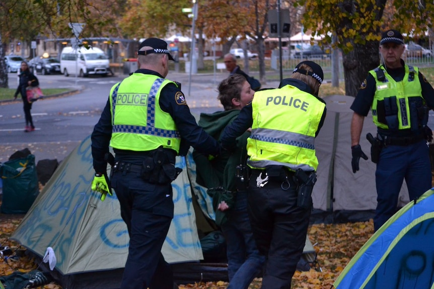 Woman is taken away from Parliament lawns homeless protest.