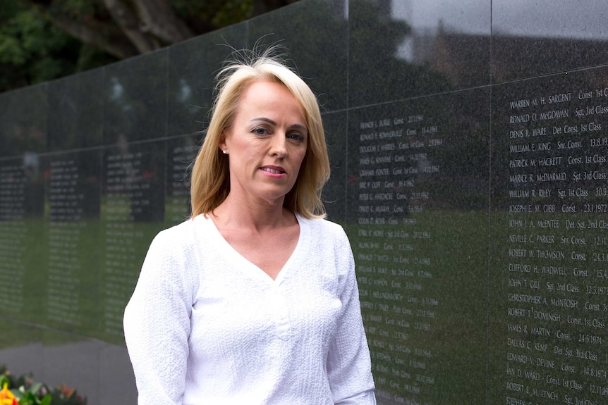 Deborah Bryant in front of the NSW police wall of remembrance.
