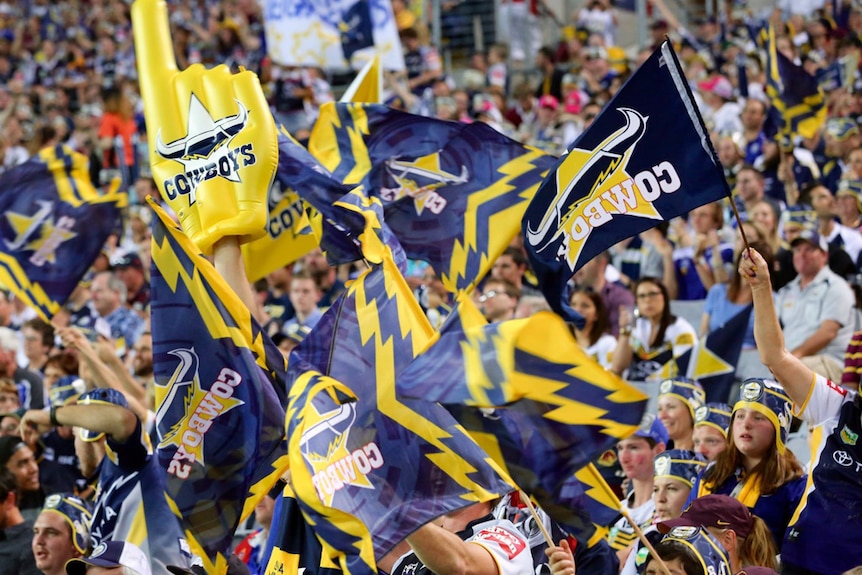 Fans fly the North Queensland Cowboys flag at a local game in Townsville.
