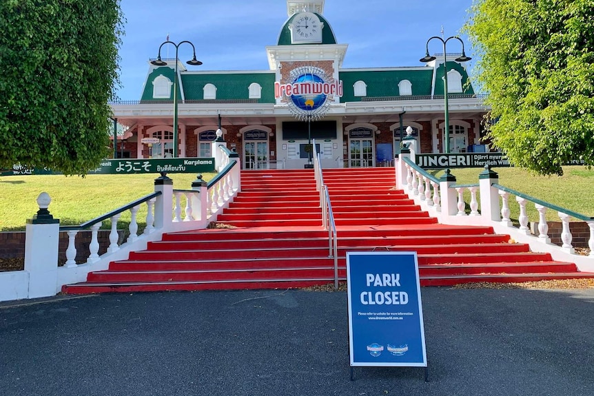 Front entrance to Dreamworld theme park with a sign at the bottom of the stairs saying 'park closed"