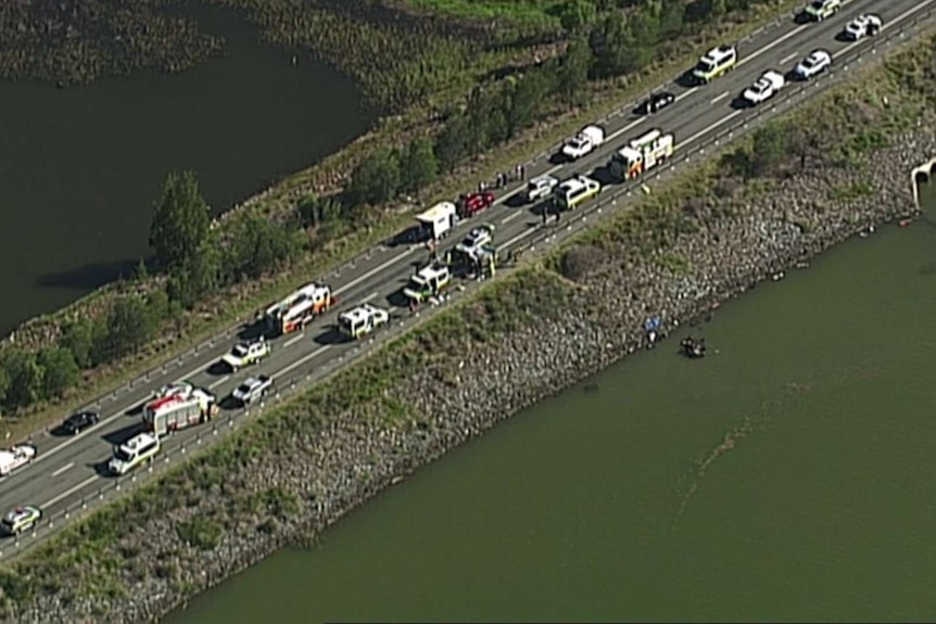 Aerial view of than a dozen fire, ambulance and police vehicles at the scene of a crash