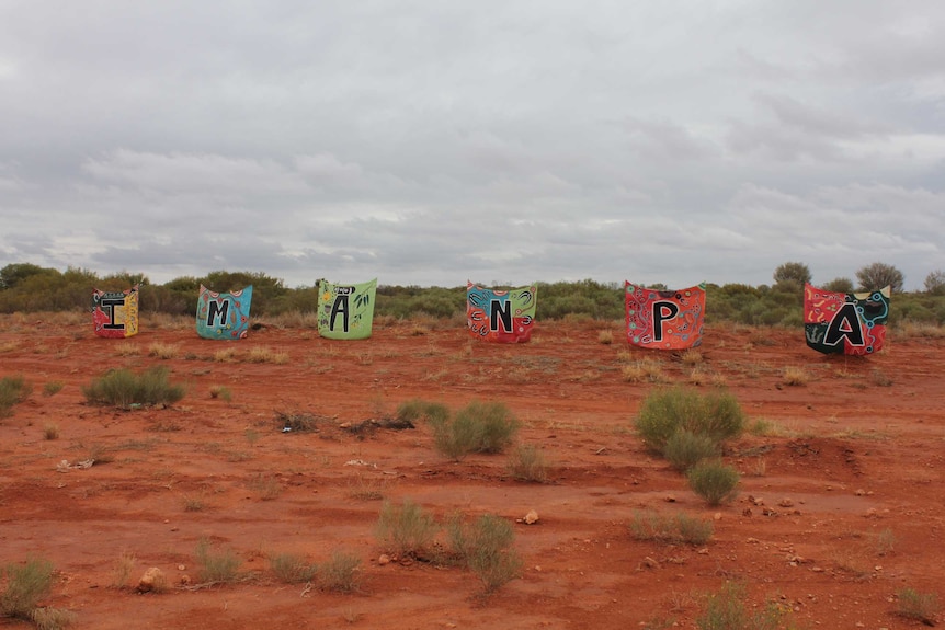 Bringht letters spelling out Imanpa in the central desert.