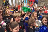 Children wave colourful streamers at a rally for marriage equality in Melbourne.
