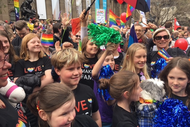 Children wave colourful streamers at a rally for marriage equality in Melbourne.