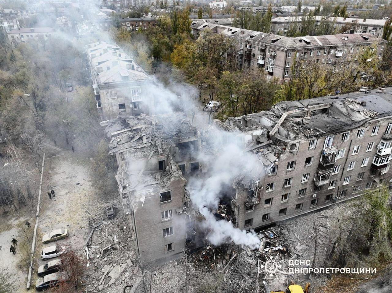 An apartment building lies in ruins following a missile strike