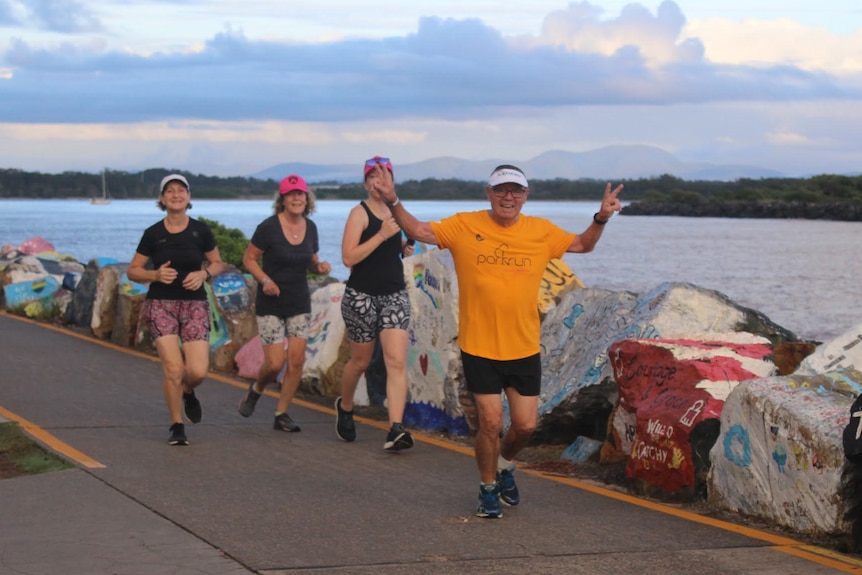 Abdon Ulloa runs along the water at Port Macquarie parkrun.