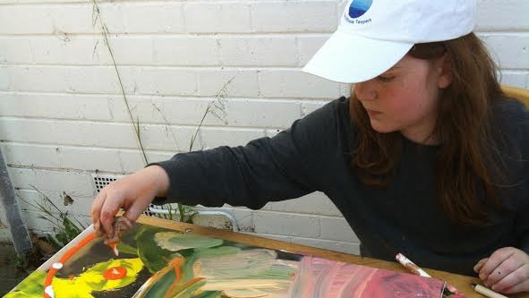 Isaac Flaherty-Stewart painting at the age of 10 as part of his home schooling.