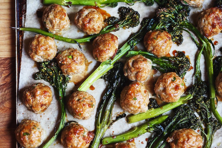 A tray of just baked pork meatballs and broccolini brushed with a sticky soy glaze, a midweek family dinner.