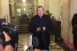 Cardinal George Pell speaking to media outside the Hotel Quirinale