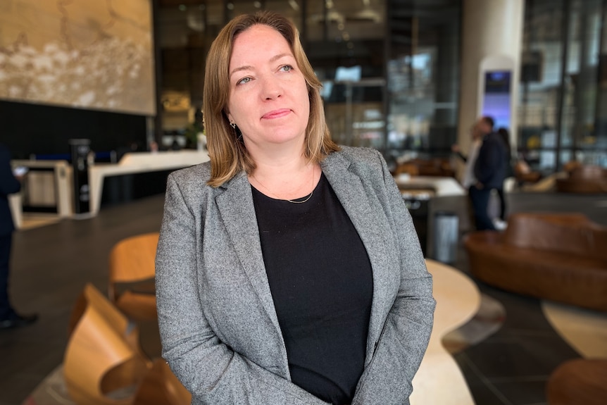 a woman in a suit smiling