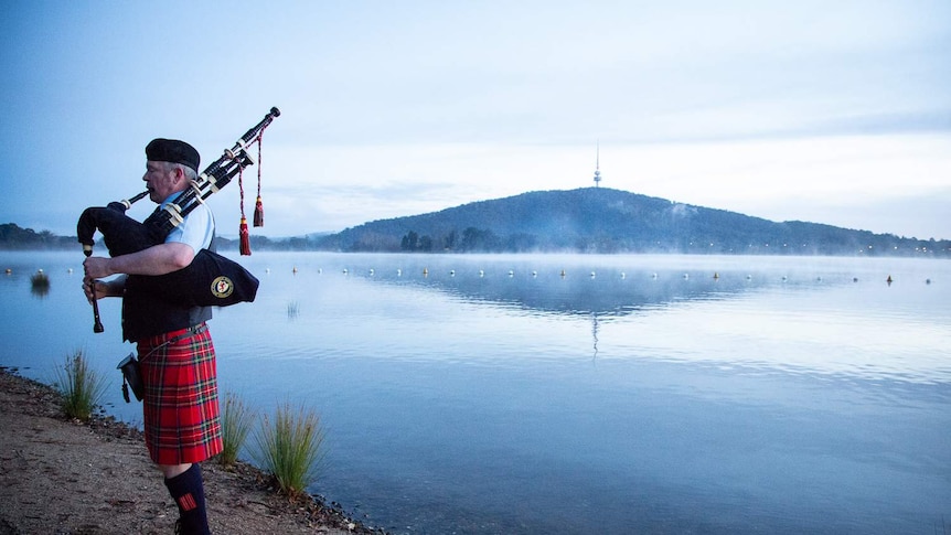 Bag piper plays the pipes beside Lake Burley Griffin