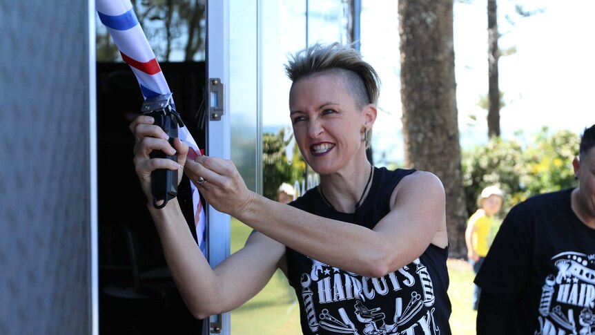 Danielle Hannah cuts the ribbon on her new mobile barbershop