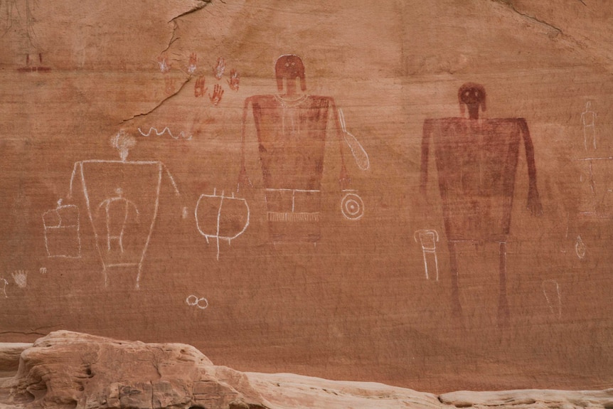 Ancient Native American images of human figures drawn onto a rock surface in Utah.