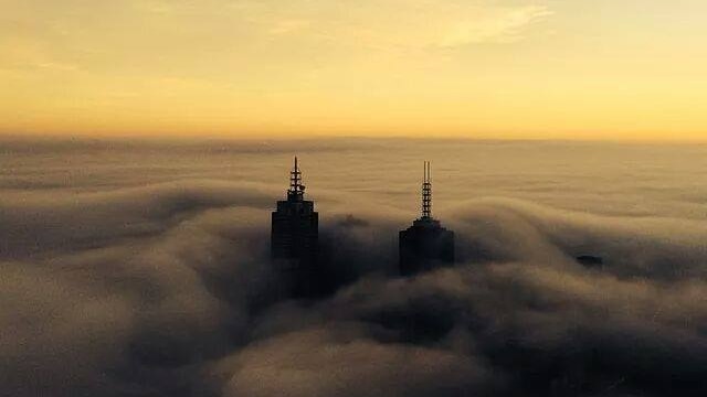 Highrise buildings poke out of fog