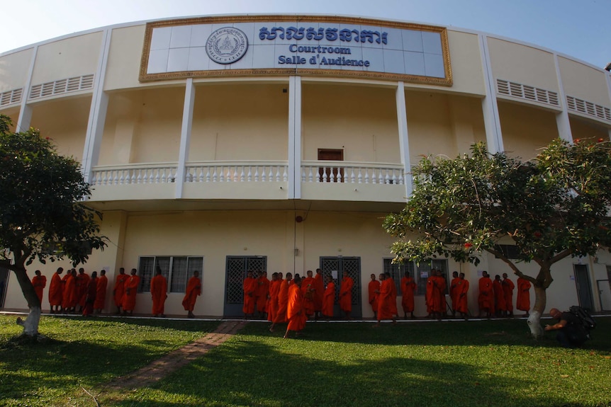 Cambodian Buddhist wait outside the court hall before attending the hearings of two Khmer Rouge senior leaders.