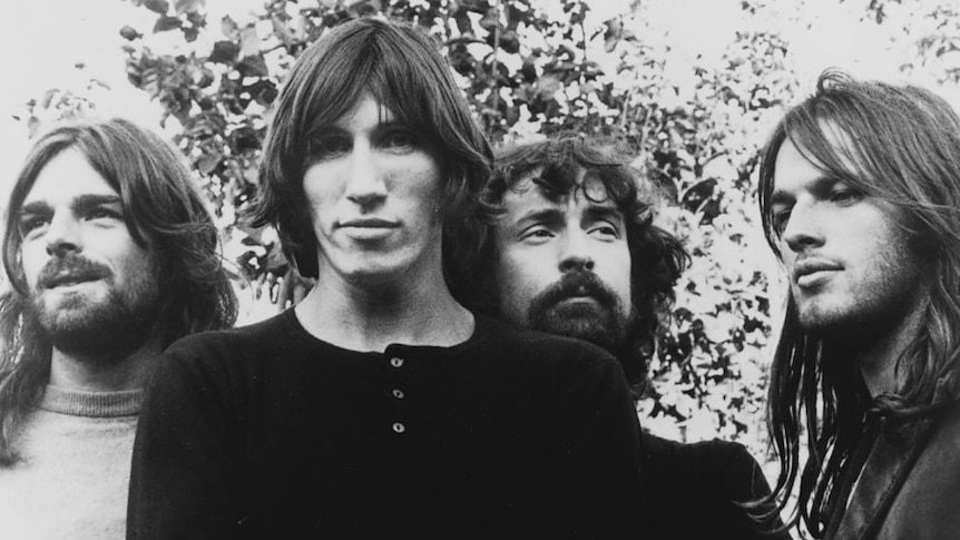 The four members of Pink Floyd pose for a publicity photo outside.