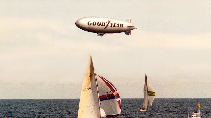 Australia II (background) and American defender Liberty race in the America's Cup