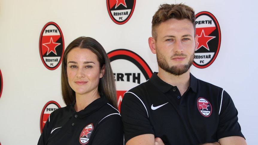 A man and woman stand side by side in shirts in front of a banner with Perth Redstar written on it