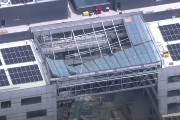 An aerial shot of a glass roof caved in.