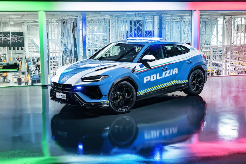 A luxury SUV with the text "Polizia" printed on the side and a police light on the roof