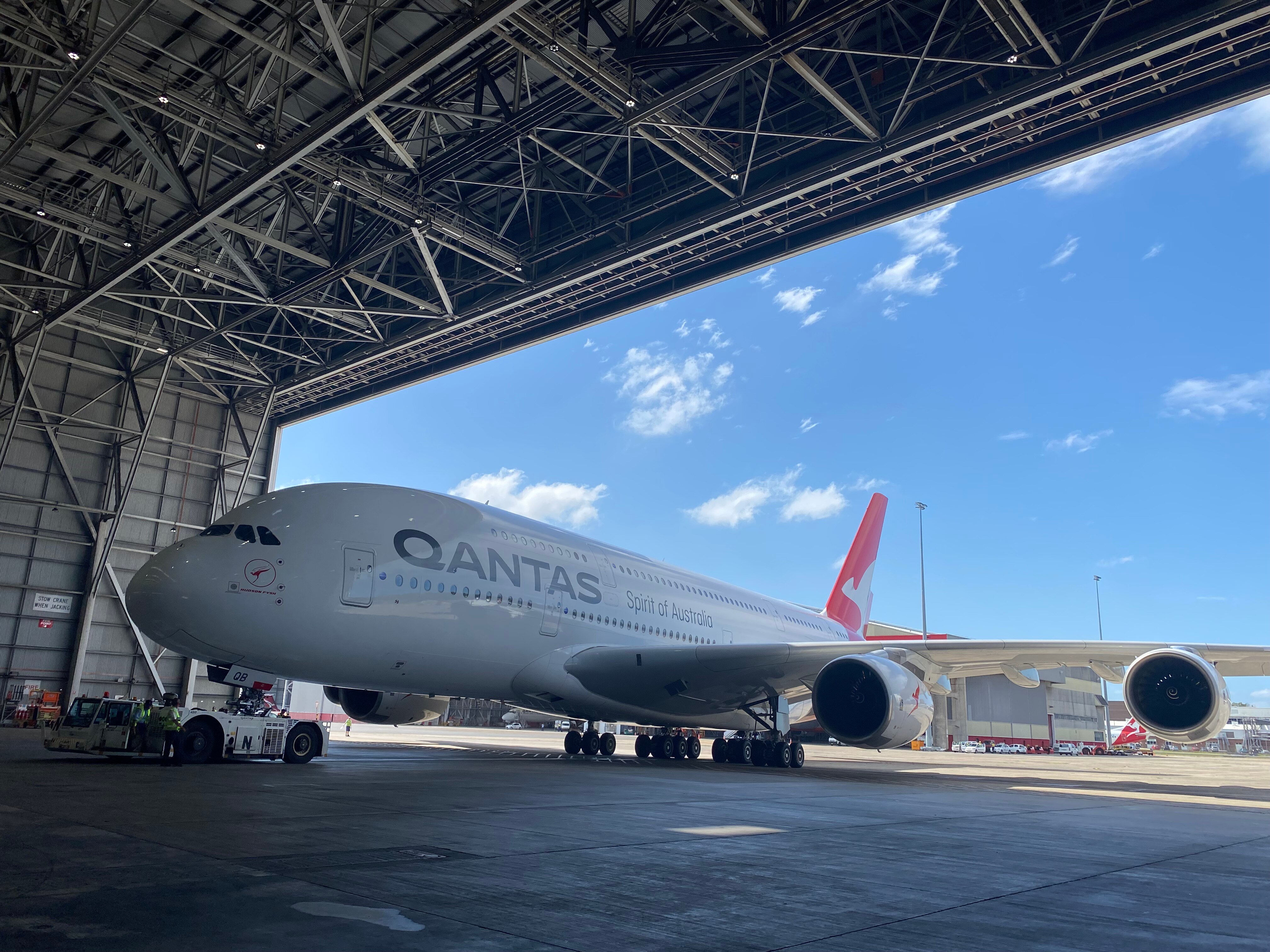 A Qantas plane enters a hanger
