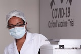 An employee wears a mask, goggles and hairnet at the Brazilian trials for the potential coronavirus vaccine developed by Oxford.
