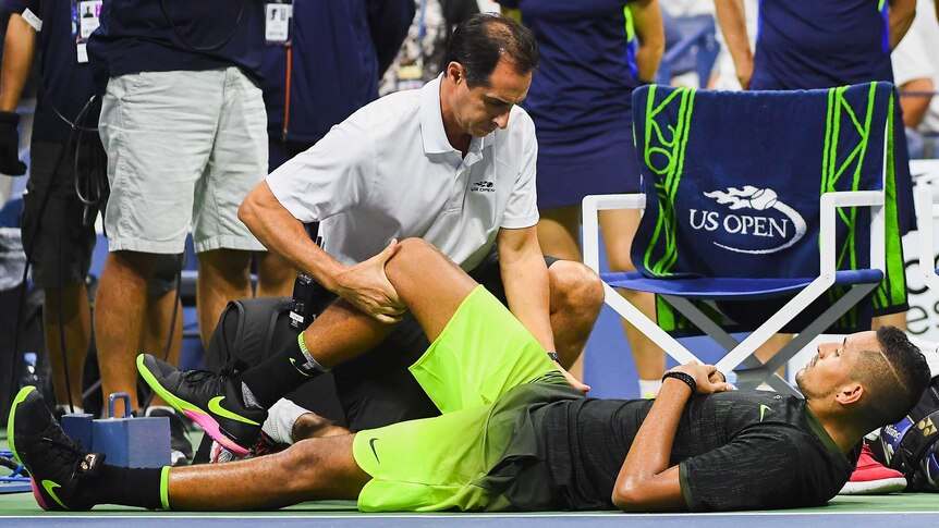 Australia's Nick Kyrgios is examined during his US Open match against Ukraine's Illya Marchenko.
