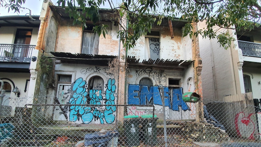 Derelict terrace houses covered in graffiti.