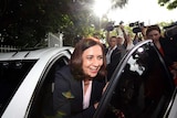 Premier-elect Annastacia Palaszczuk greets waiting media outside Government House in Brisbane.