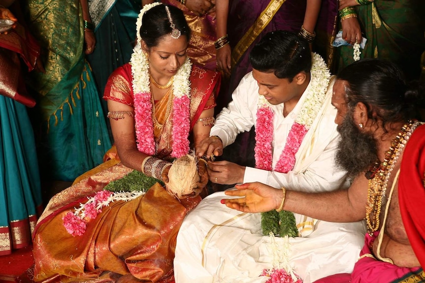 A couple marry in a traditional Indian wedding.