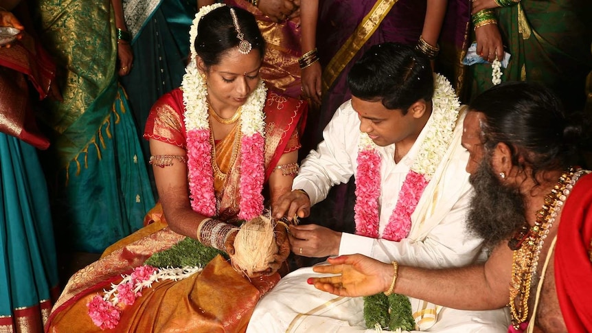 A couple marry in a traditional Indian wedding.