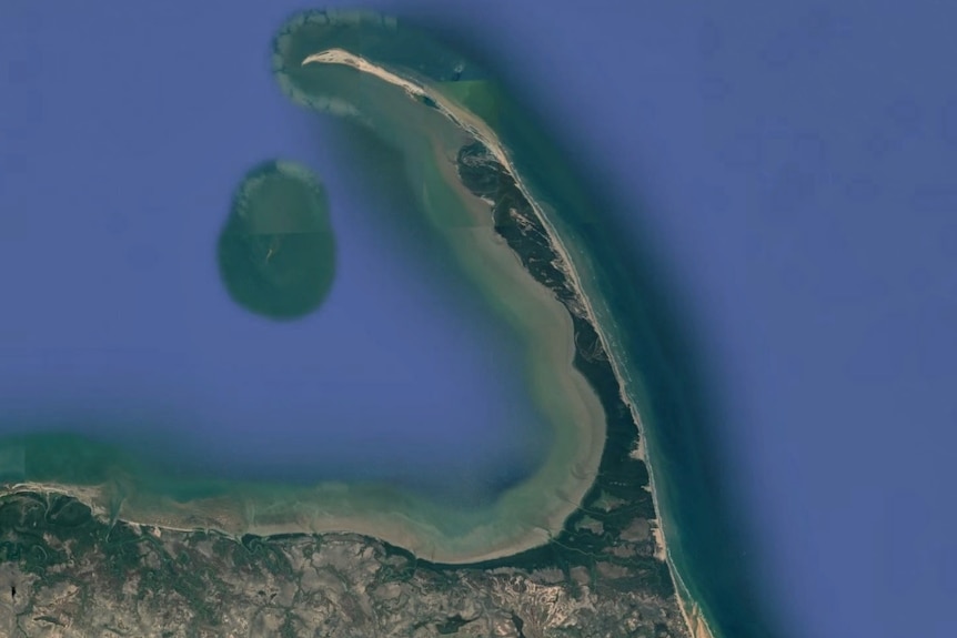An aerial view of a peninsula jutting out from the land into the sea.