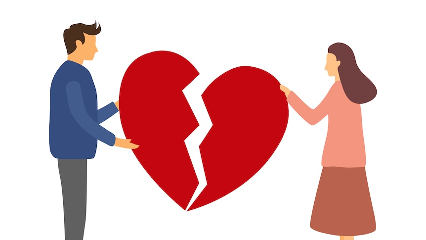 Two people standing either side of a broken heart