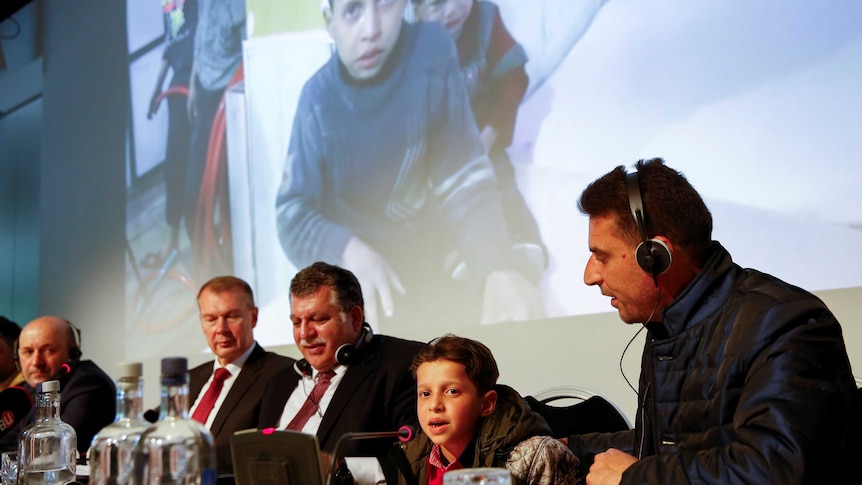 An unidentified boy from Douma, Syria, speaks at a news conference.