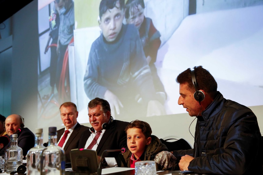 An unidentified boy from Douma, Syria, speaks at a news conference.