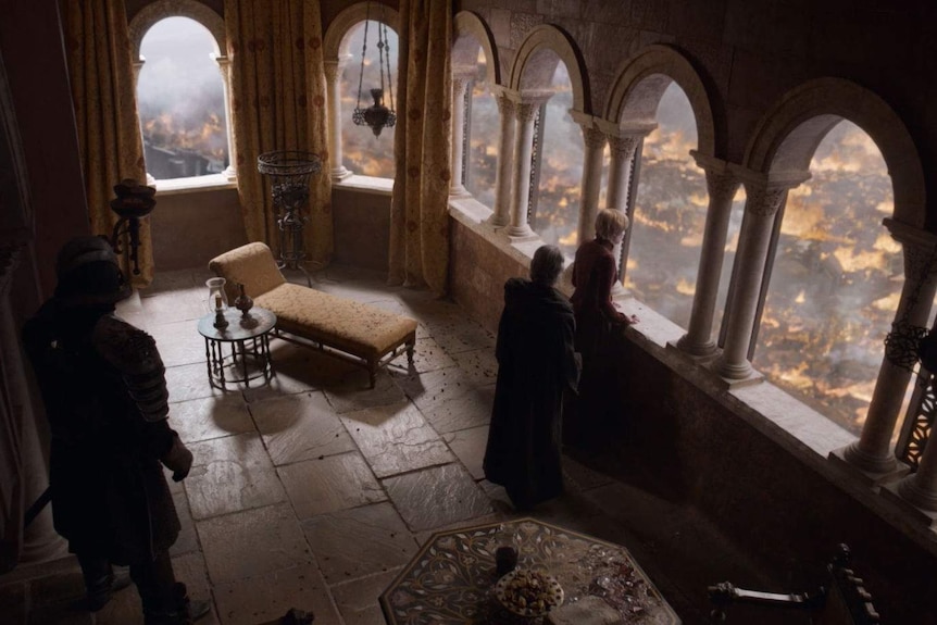 Cersei watches from her castle as King's Landing burns.