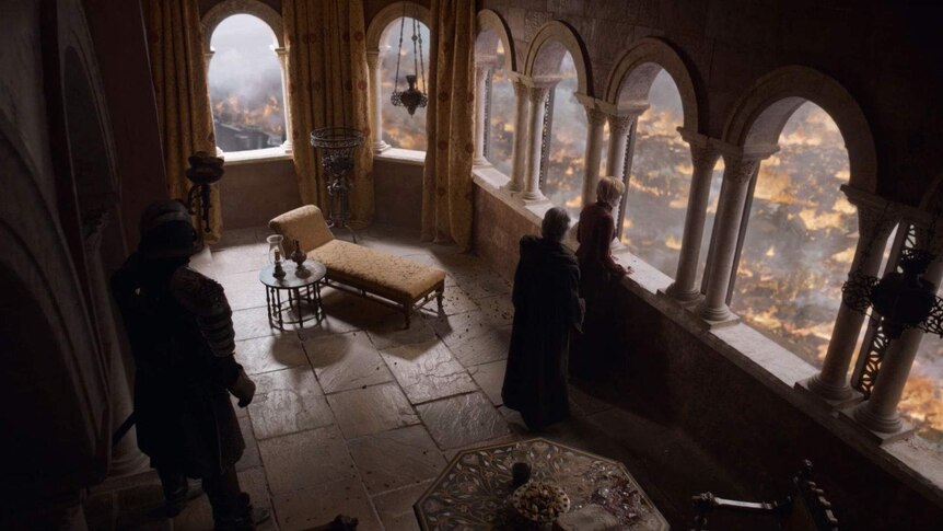 Cersei watches from her castle as King's Landing burns.