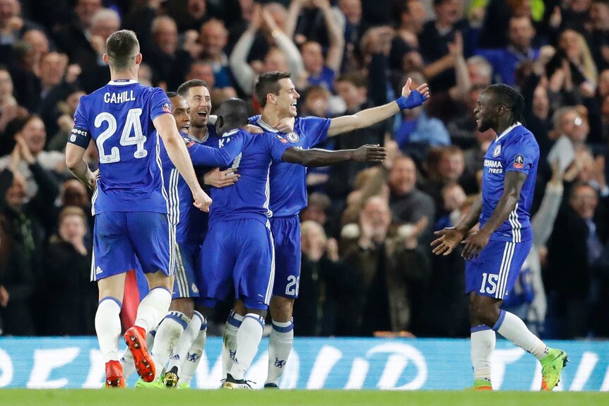 Chelsea players celebrate scoring a goal against Manchester United in the FA Cup quarter-final.