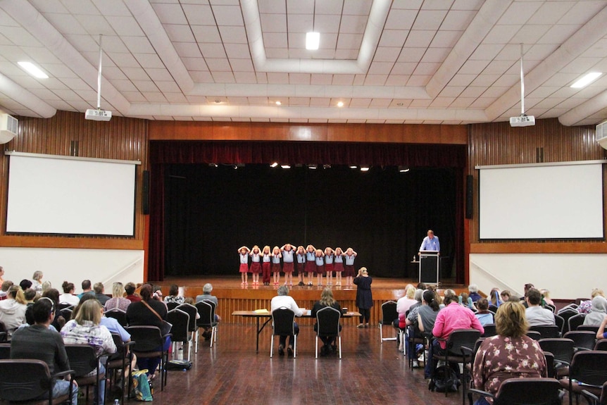 Children on a stage in front of judges and audience.