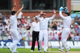 England's Graeme Swann celebrates the wicket of Australia's Usman Khawaja