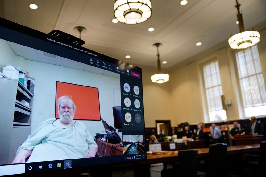 A man appearing via video link in a court room 
