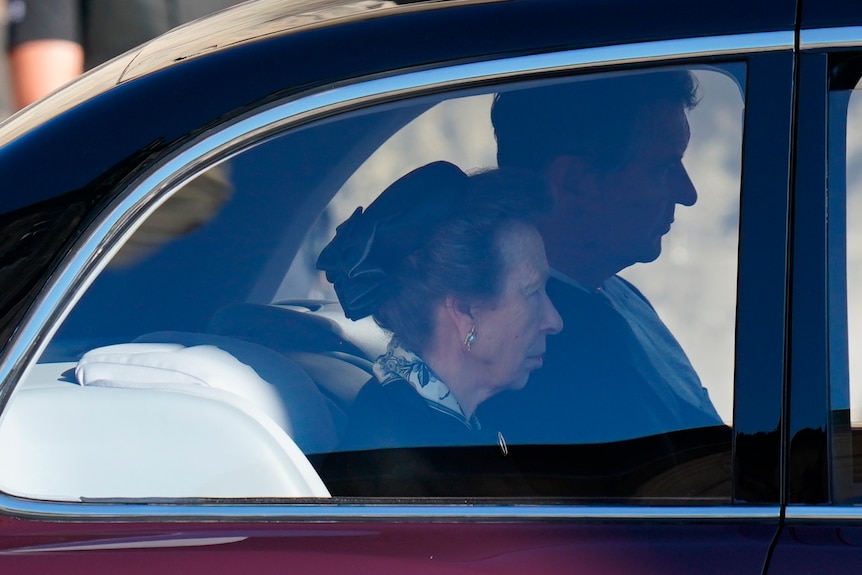Princess Anne is seen through a car window looking straight ahead