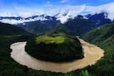 A river wraps in a sharp bend around mountain along the Yarlung Tsangpo river in Tibet
