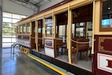 A tram from 1970s, in mint condition, sits in a museum.